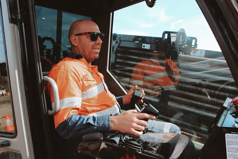 Spot On operator seated at the controls inside the drilling rig.