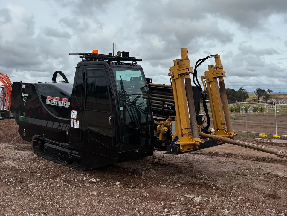 Spot On branded Vermeer directional drilling rig on a worksite.