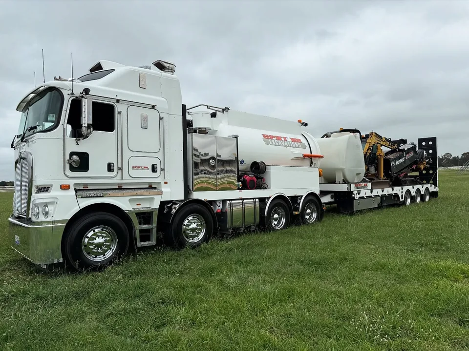 Spot On vacuum truck and directional drill set up together on a worksite.